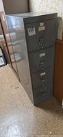 Full view of grey 4-drawer Shaw Walker cabinet