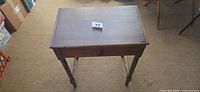 Top view of wooden side table showing drawer knob and rectangular top