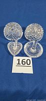All four Waterford crystal pieces grouped: two paperweights, two ring holders