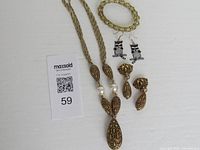 Necklace, both earring pairs and bracelet laid out together