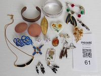 All seventeen costume jewelry pieces arranged on white background