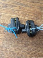 Two dark grey Master Lock trigger locks tied together