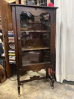 Full front view of cabinet showing glass door and shelves