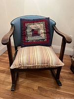 Front view of rocking chair with cushion and pillow