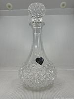Full view of crystal decanter with stopper attached