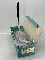 Open Copley box showing knives in plastic sleeves