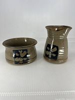 Creamer and bowl front view showing glaze and decorative panels