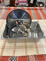 All four bakeware items grouped: stainless roaster holding Olympia Inox dish, springform ring, glass loaf dish