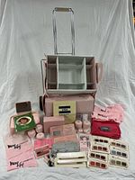 Full lot with wheeled case, cosmetics, brushes and cloths laid out