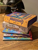 Stack showing boxed set on top of five loose paperbacks