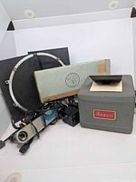 Group shot showing Ansco projector, light panels, reflector ring, storage envelope, power cords
