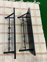 Pair of wall racks side view showing metal hooks and depth from backboard