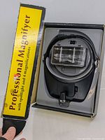Magnifier in open box with lid showing product name