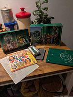 Box opened showing DVDs, watch, books and ephemera