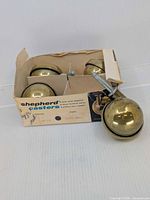 Four brass ball casters in original Shepherd box