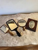 All four handheld mirrors laid out