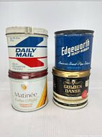 Front view of all four tins showing brand labels