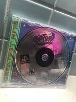 Front of jewel case showing Spyro 2 disc and green Greatest Hits spine