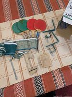 Full set laid out: four paddles, net, posts, clamps, rule sheet