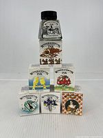 Group shot of all seven ink colours with boxed inks arranged in pyramid and Black bottle on top