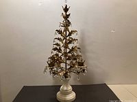 Full front view of gilt metal tree form girandole candelabra showing crystals and marble base