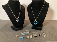 Full lot view: necklaces on busts, bracelet, rings and earrings