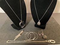 Full lot view showing necklaces on stands, bangles, earrings, ring, chain link necklace