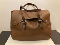 Front view of brown leather MO851 tote bag