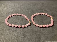 Both pink quartz bead necklaces laid flat showing complete strands and clasps