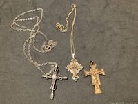 Three cross pendants and two chains overview