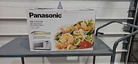 Front of sealed Panasonic NN-ST651W microwave box