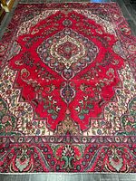 Full view of Persian Tabriz rug showing overall design and colors