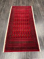 Full view of Turkman rug on dark wood floor