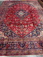 Full view of Persian rug showing overall design and borders