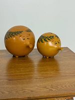 Front view of both piggy banks displaying size difference and decoration