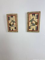 Both chalkware plaques hung side by side on wall