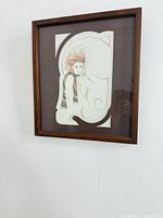 Lithograph in brown wood frame mounted on wall
