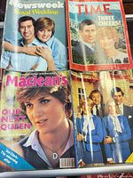 Four magazines displayed on surface