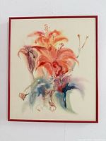 Frontal view of signed watercolour floral painting in red frame