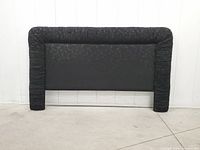 Front view of black and purple floral upholstered headboard