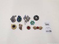 All eight brooches laid out for full view