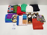 All 13 folded silk scarves grouped on table