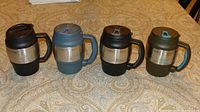 Four Bubba insulated travel mugs, assorted colors on table