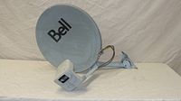 Full view of Bell satellite dish showing logo, LNB block, coax leads and mounting bracket