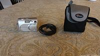 Front view of Fujifilm FinePix A210 camera, cable, and Lowepro case
