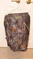 Front view of RealTree insulated hunting pants hanging
