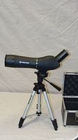 Scope mounted on tripod, case beside