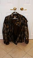 Front view of Remington camouflage jacket on hanger