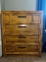 Front view of chest showing faux bamboo frame and four drawers