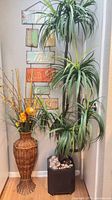 Faux palm tree, rattan floral arrangement and metal wall hanger together